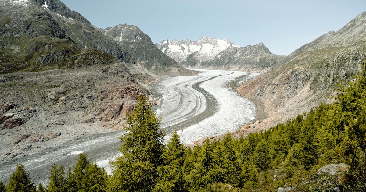Breathtaking view of Aletsch Glacier surrounded by alpine landscape in Switzerland.