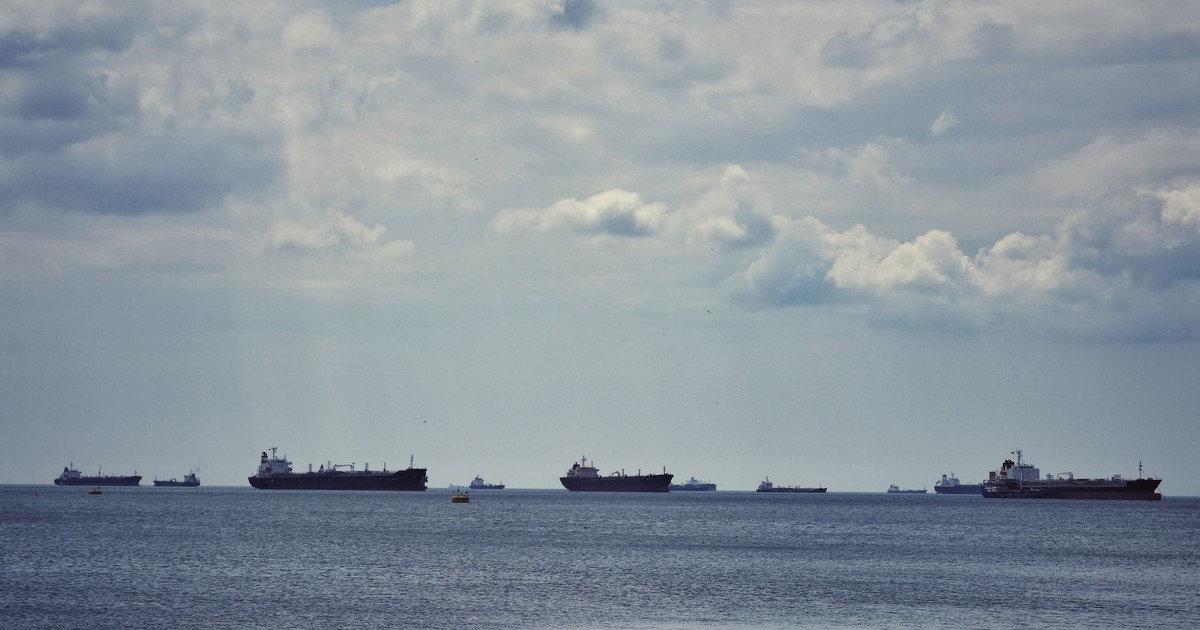 Scenic view of multiple cargo ships anchored on the Bosphorus Strait under a cloudy sky in İstanbul.