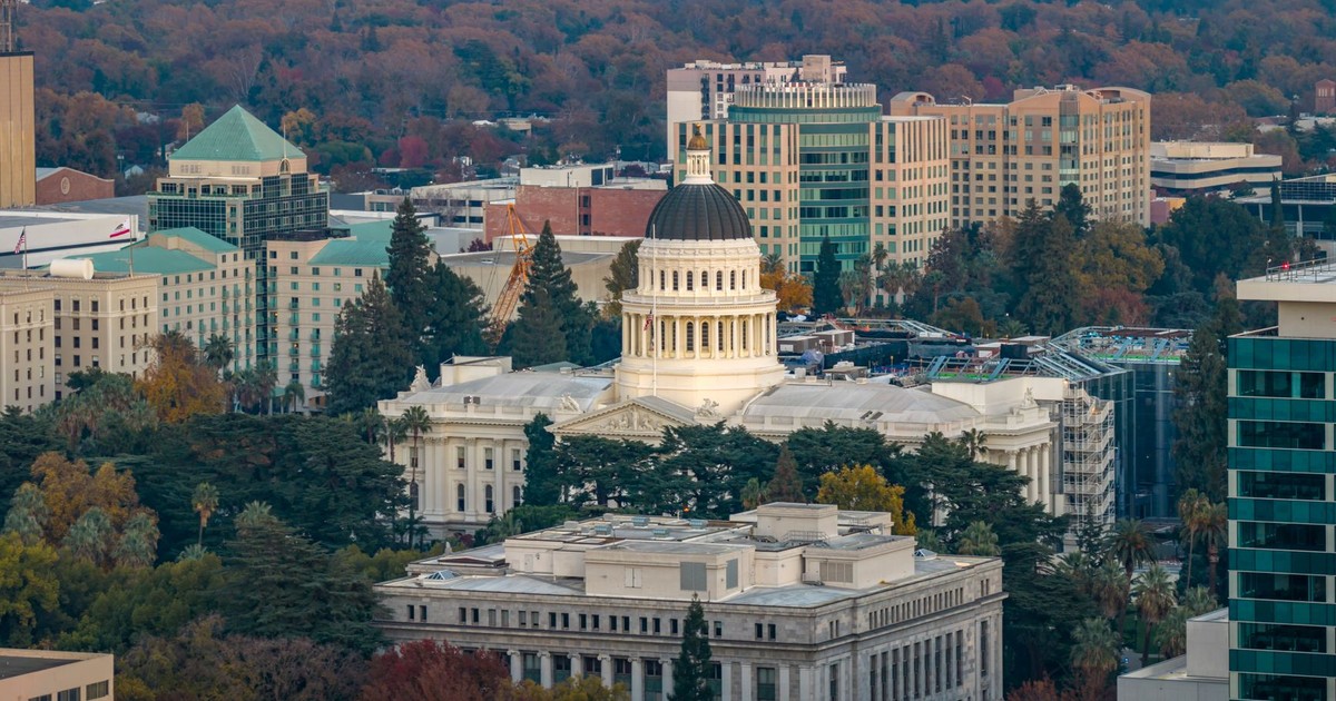 Stunning aerial view of the iconic California State Capitol in Sacramento surrounded by cityscape.