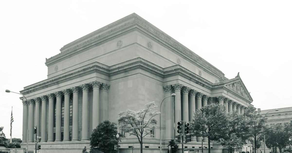 Black and white photo of the National Archives Building in Washington D.C., showcasing its neoclassical architecture.
