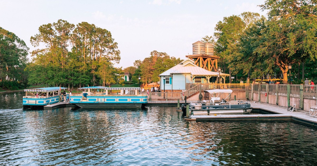 Peaceful scene of boats docked at Port Orleans Riverside during sunset.
