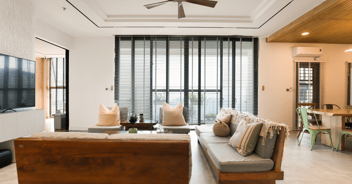 Spacious and stylish living room featuring large windows and modern decor elements.
