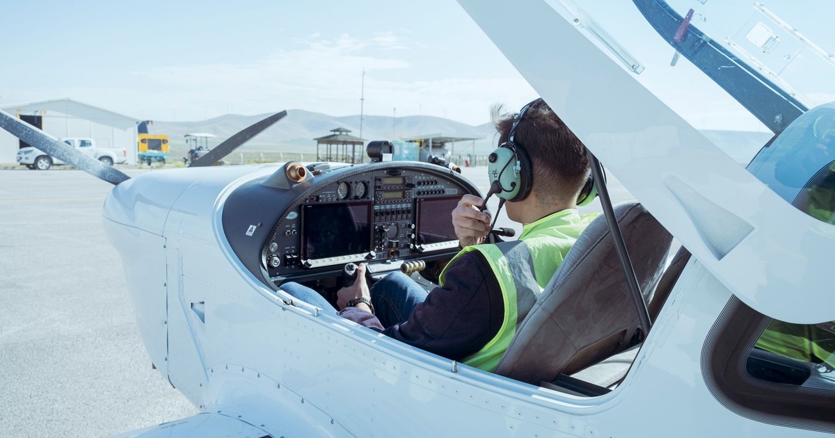 A pilot in the cockpit of a small aircraft readying for flight at Konya Airport, Türkiye.