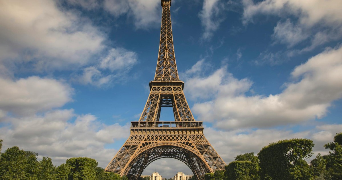 A breathtaking view of the Eiffel Tower against a blue sky in Paris, France.
