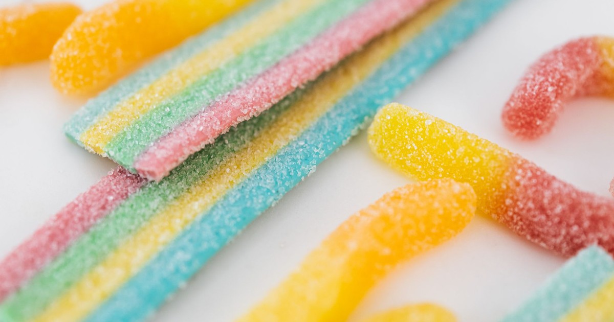 Vibrant close-up of assorted sugary candies on a clean white surface.