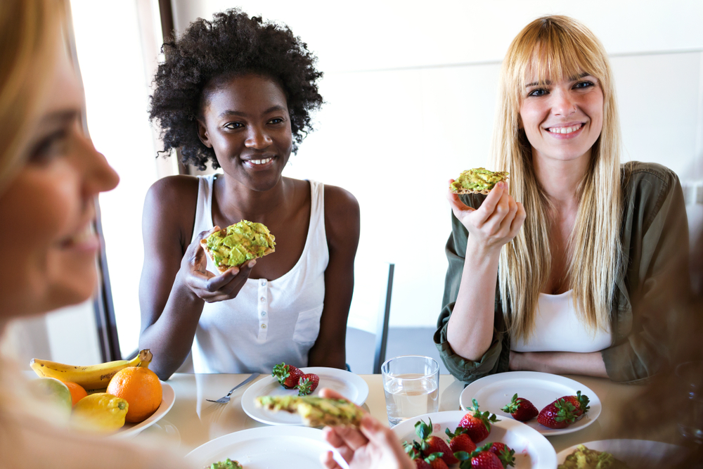 group of friends eating avocado toast