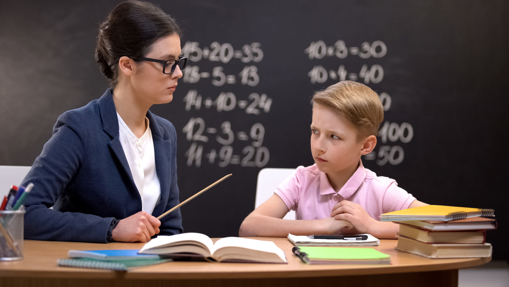 teacher in front of blackboard