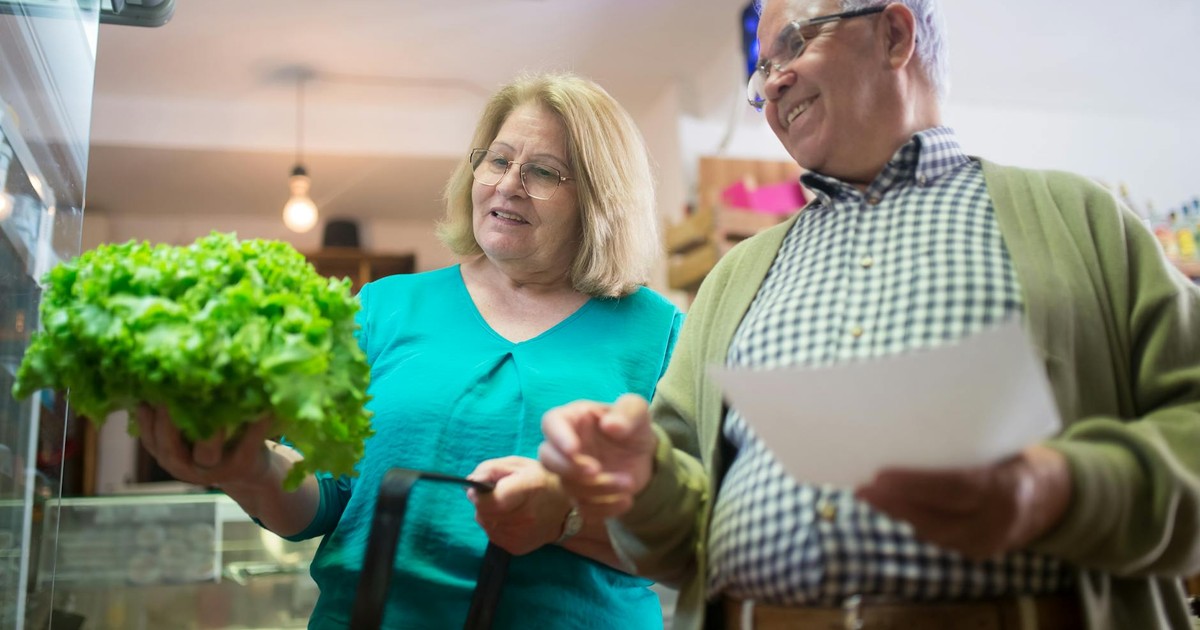 Happy senior couple shopping for fresh vegetables together, enjoying a day out.