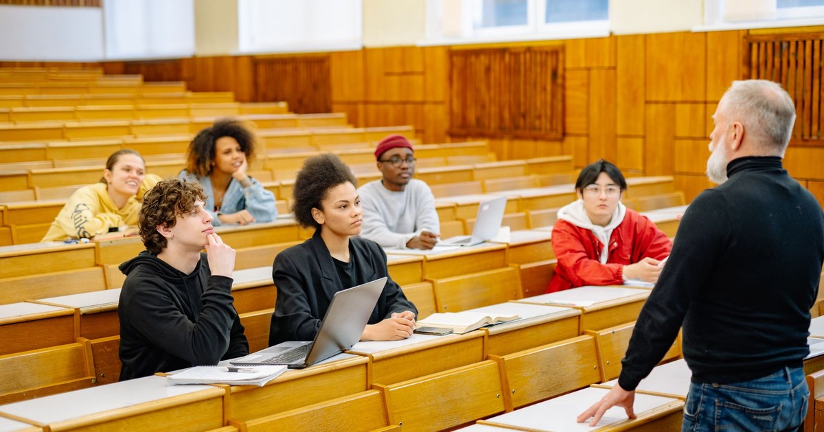 University students engaging in a diverse classroom setting with a lecturer.