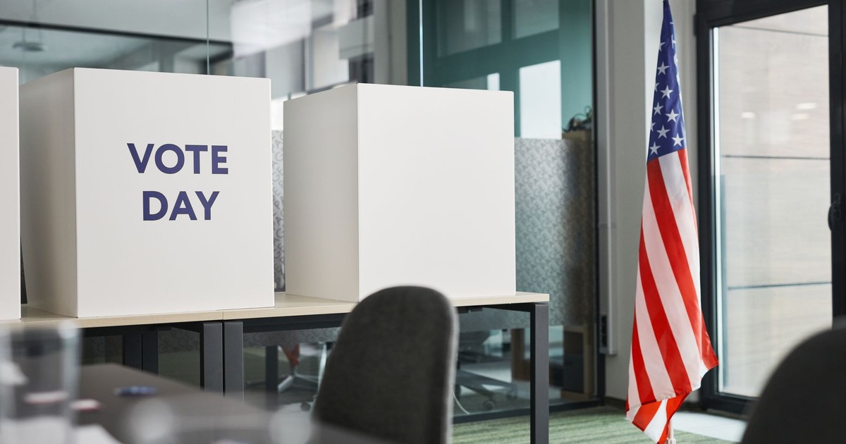 Voting booths with an American flag in an office, symbolizing Election Day.