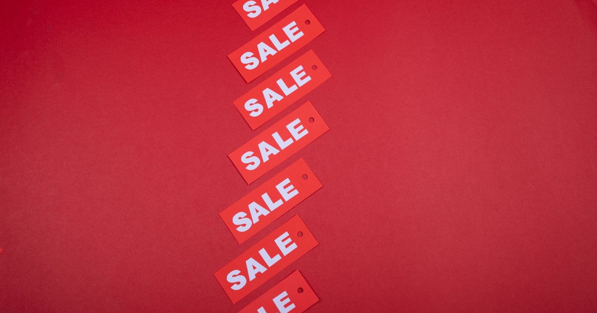 Diagonal row of red sale tags on a red background. Ideal for advertising promotions.