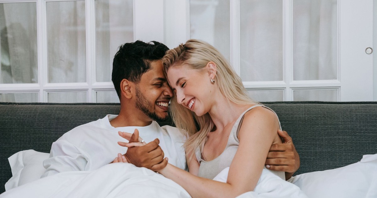 Affectionate couple sharing a joyful moment indoors, expressing love and happiness.