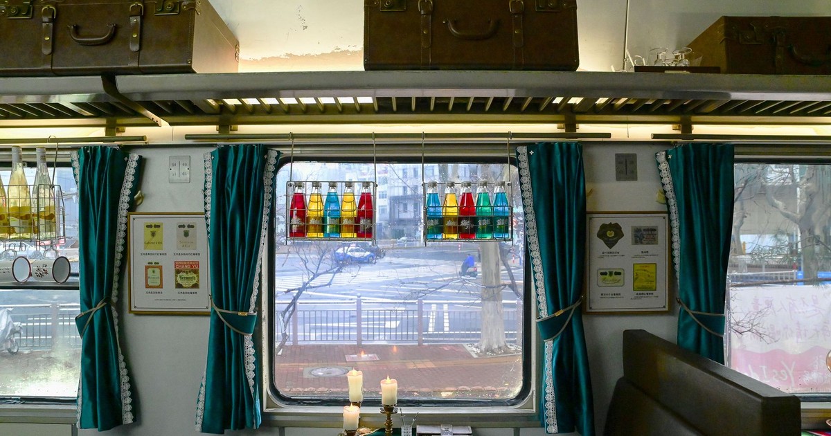Cozy dining car interior with vintage decor and colorful bottles, Yantai, China.