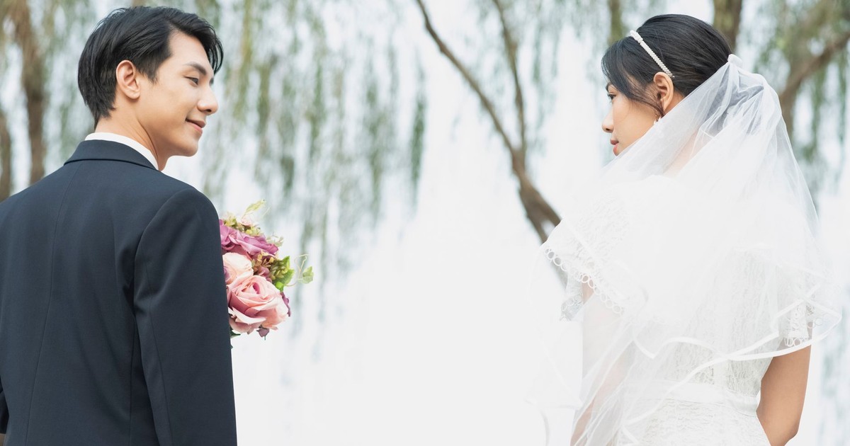 Bride and groom in a serene outdoor setting, capturing a romantic moment.