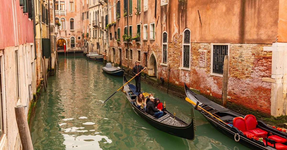 Gondolas on a charming Venetian canal surrounded by historic architecture in Venice, Italy.