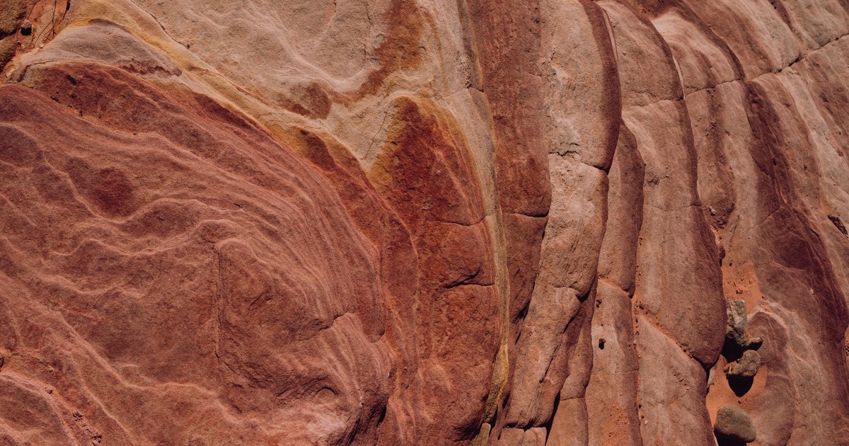 Detailed view of textured orange rock formations showcasing natural erosion in a canyon.