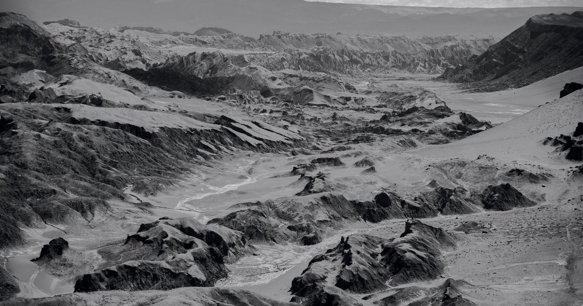 Black and white landscape of Moon Valley, Chile, showcasing rugged terrain.