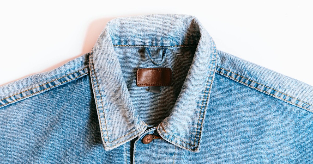 Blue denim jacket collar close-up on a white background, showcasing classic style.