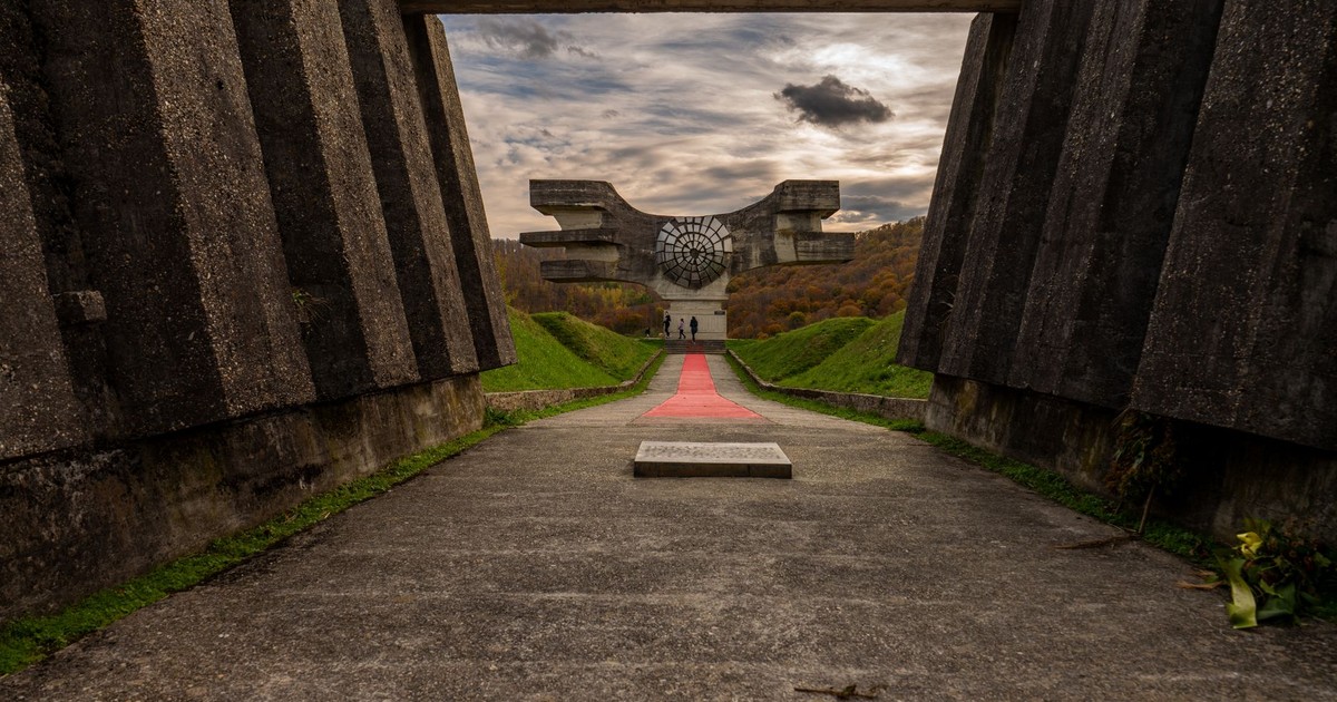 A striking view of the Monument to the Revolution in Podgarić with dramatic skies.