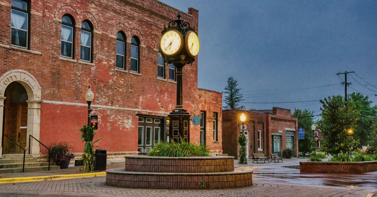 Charming brick building with unique street clock in Wabasha, Minnesota. Urban historic scene at dusk.