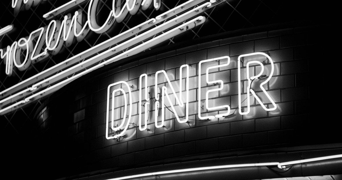 High contrast neon diner sign in black and white, evoking classic Americana.