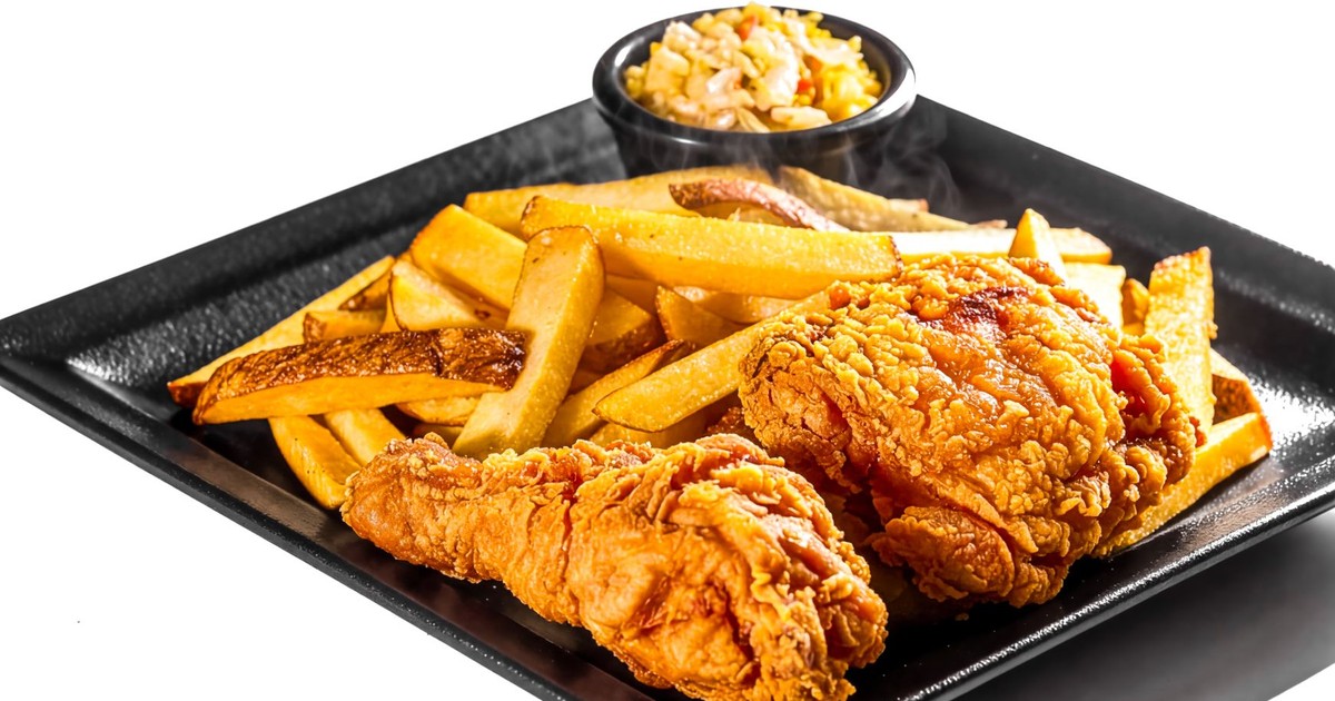 Delicious fried chicken served with crispy fries and coleslaw, ideal for comfort food lovers.