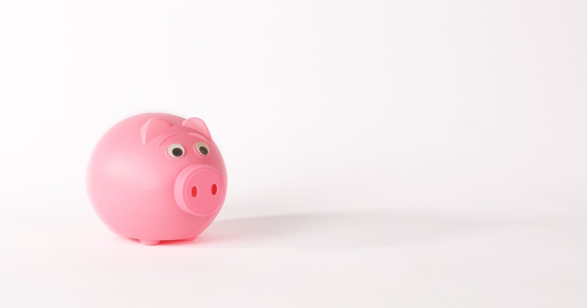 Cute pink piggy bank isolated on white background representing savings and finance concepts.