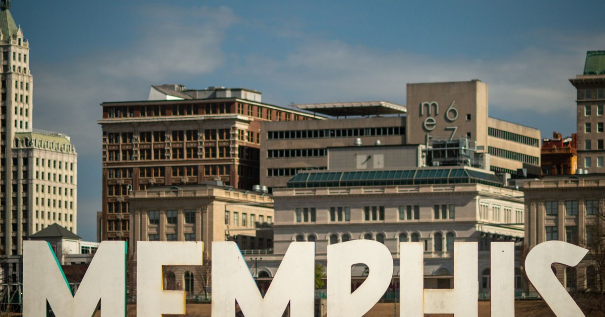 View of the Memphis sign set against the historic city skyline, showcasing iconic architecture.