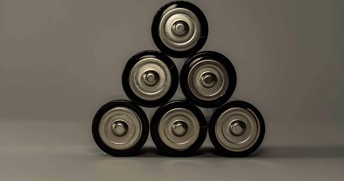 Metallic AA batteries stacked in a pyramid shape, symbolizing power and energy storage.