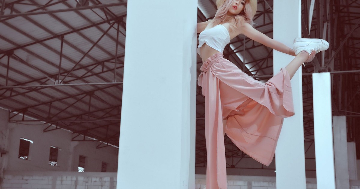 Fashionable woman striking a pose indoors in an industrial building, Phnom Penh.