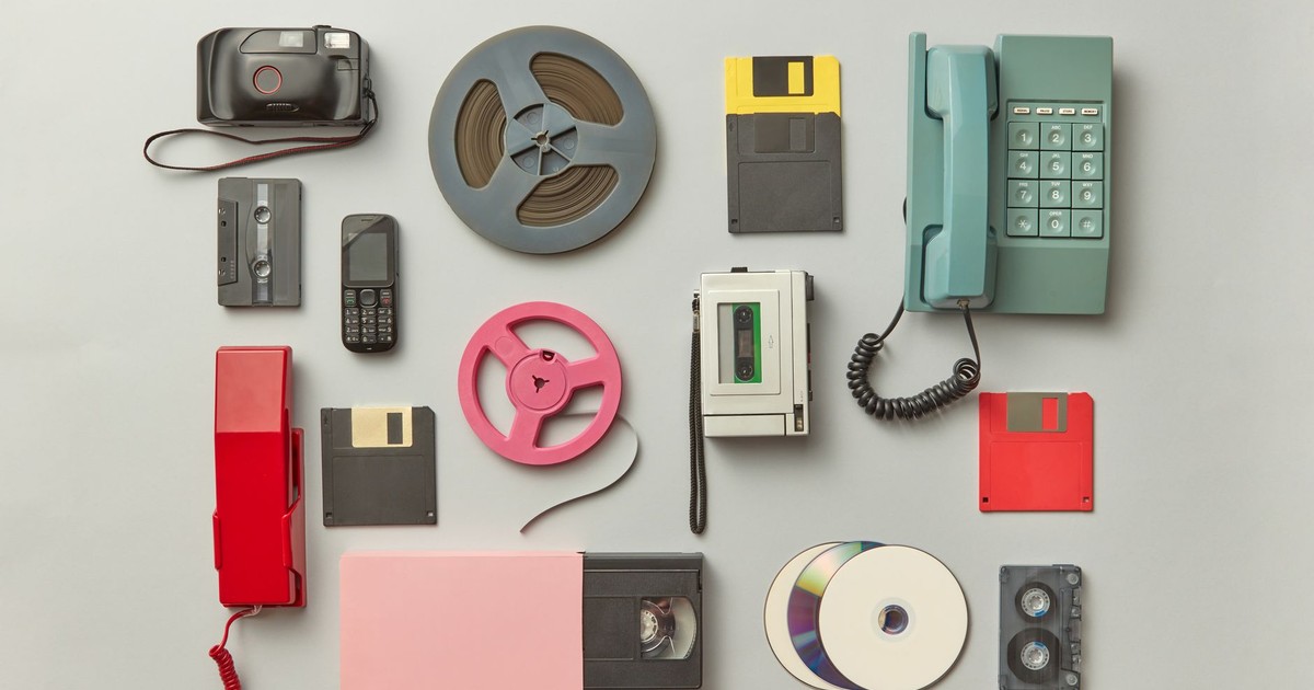 Collection of vintage gadgets including telephones, cassettes, and floppy disks.