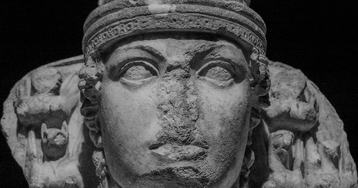 Close-up of an ancient Greek goddess sculpture, highlighting detailed carving.