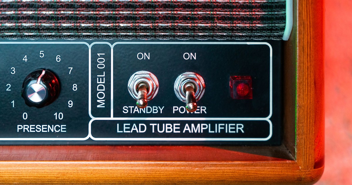 Detailed view of a vintage lead tube amplifier with control switches.