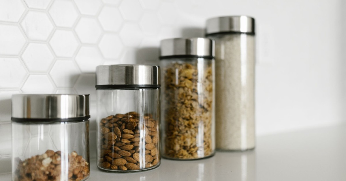 Stylish glass jars filled with food for a modern kitchen organization.