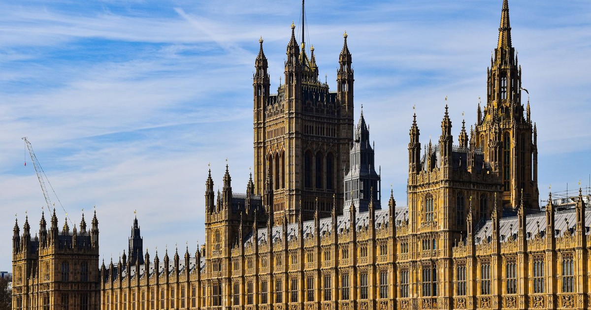 Stunning view of the historic Palace of Westminster in London under a clear blue sky.