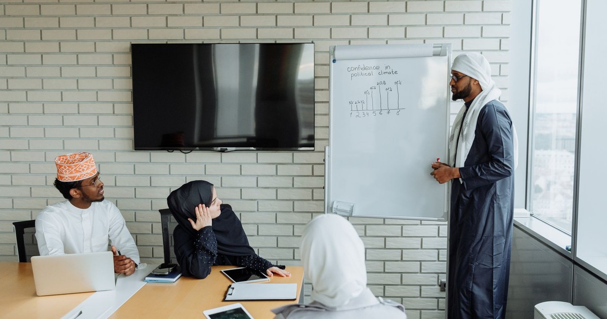Business meeting with a diverse team engaging in a presentation with visual aids in a modern office.