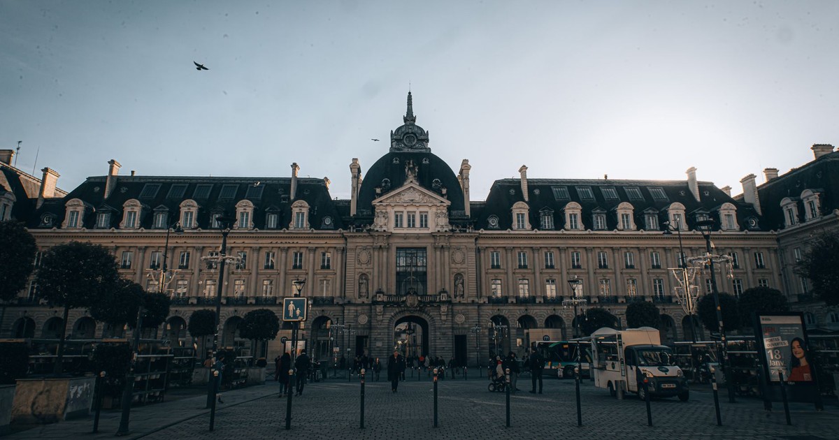 A grand historic building with classic architecture under twilight skies in an urban setting.