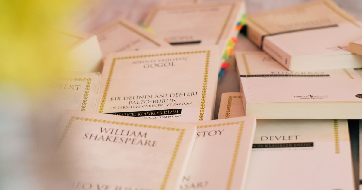 A collection of classic literature books laid out on a table.