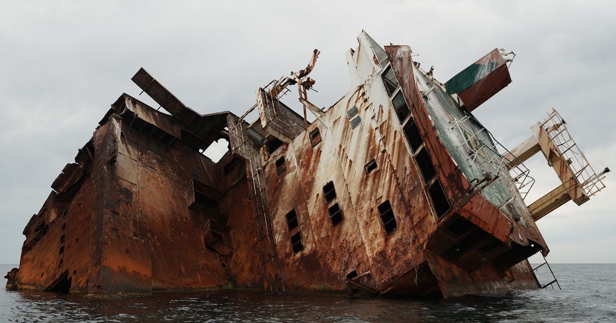 Dramatic shot of a rusty, abandoned shipwreck partially submerged in the Black Sea.