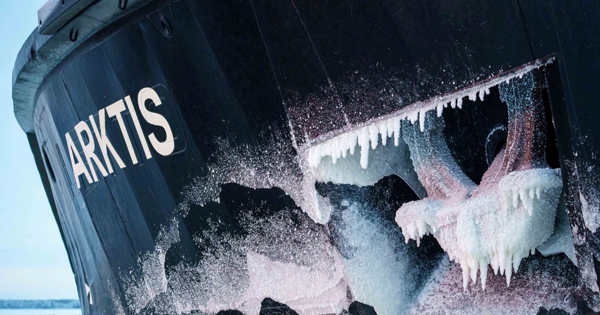 Close-up of an icebreaker ship's frozen bow in the Arctic with icicles.