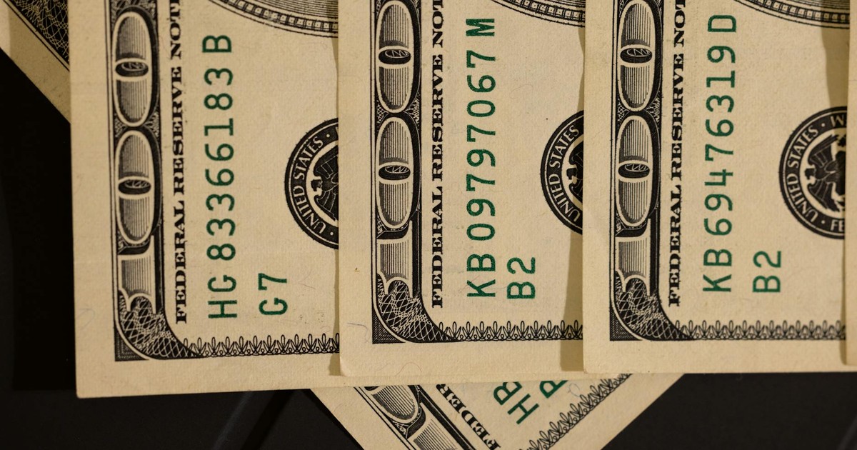 Detailed close-up shot of US dollar bills displaying serial numbers and Federal Reserve details.