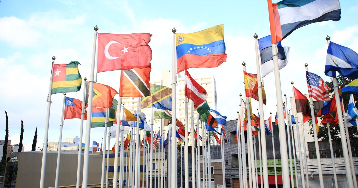 A vibrant collection of international flags in a cityscape setting, symbolizing global unity.