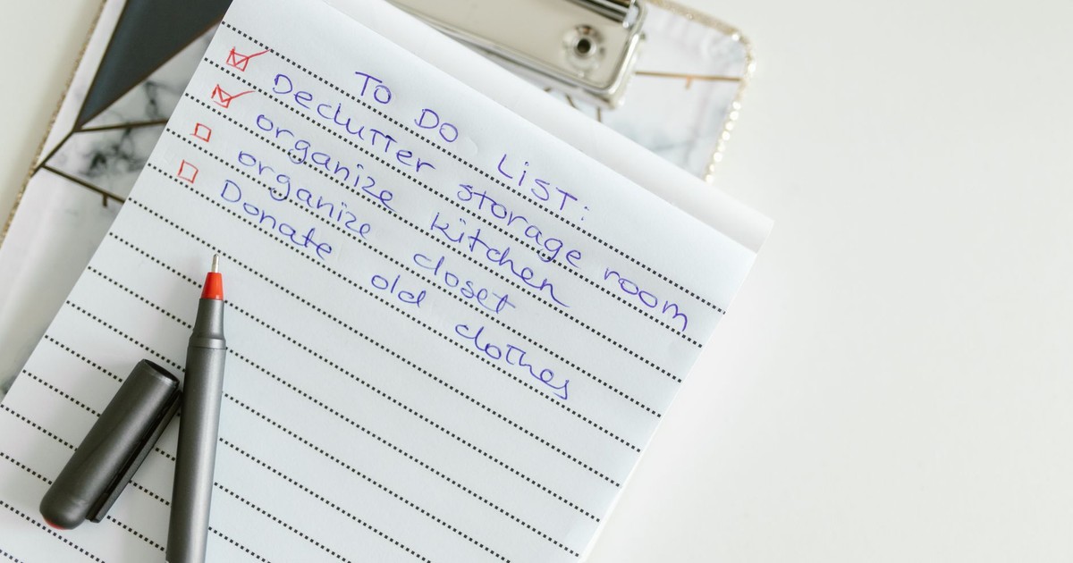 A neatly written to-do list on lined paper with a pen, perfect for organizing tasks.