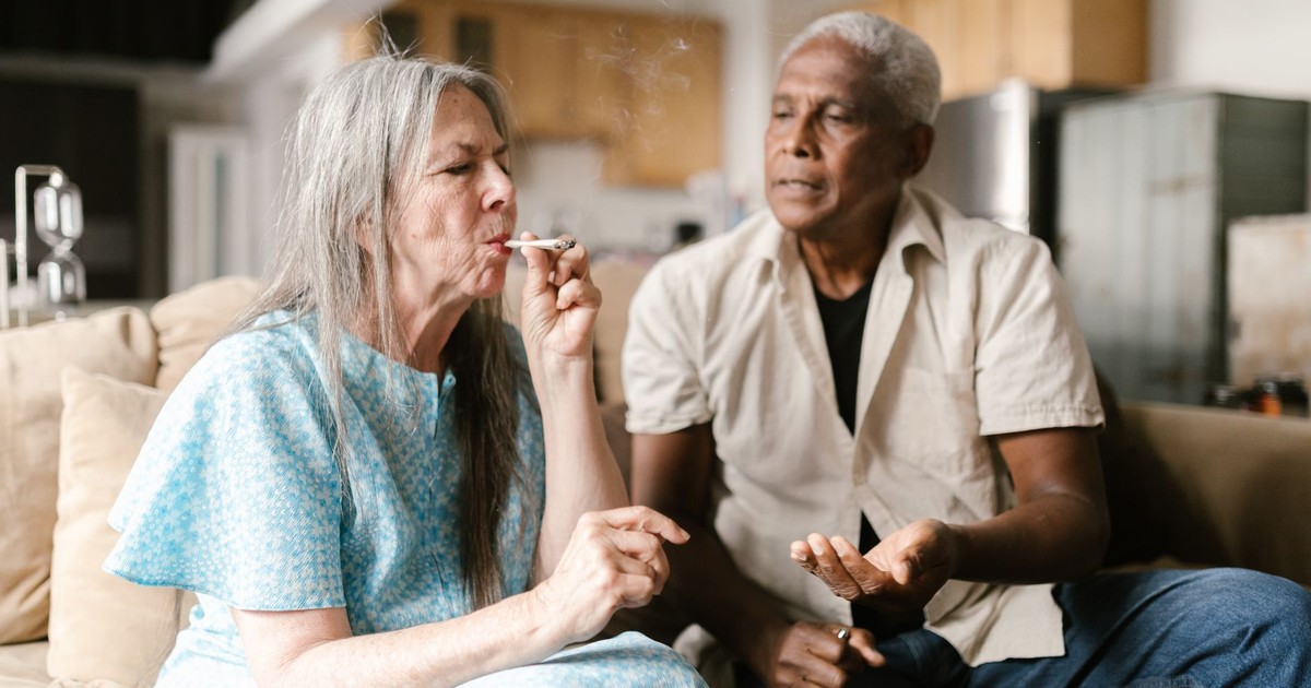 Senior adults sharing a moment with medical marijuana indoors.