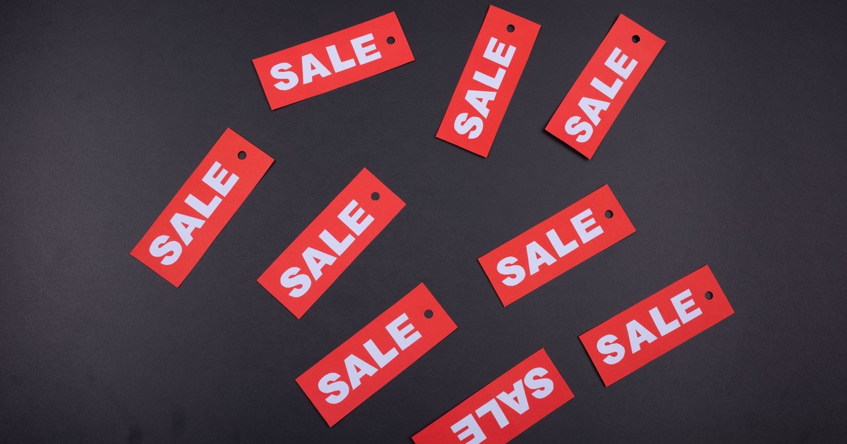 Red sale tags arranged on a dark background, ideal for retail promotions.