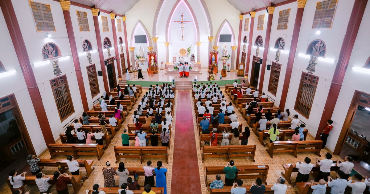 A vibrant congregation gathers in a beautifully lit church for worship.