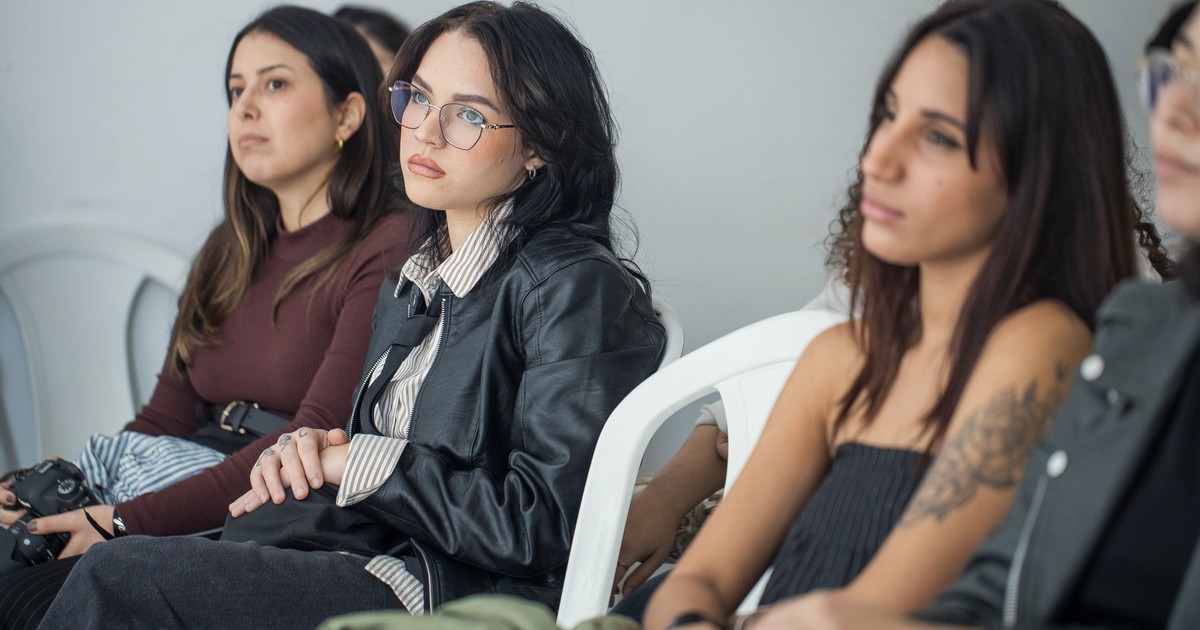 Focused individuals attending an indoor seminar, showcasing engagement and learning.