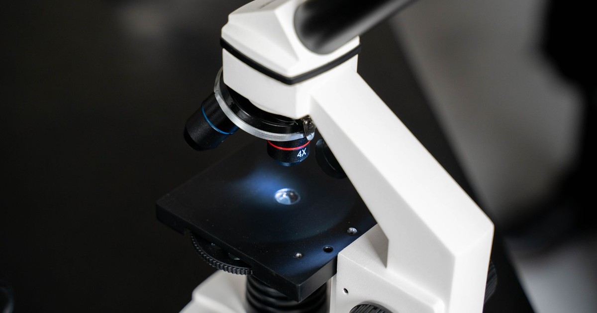 Close-up view of a laboratory microscope with selective focus, ideal for scientific use.