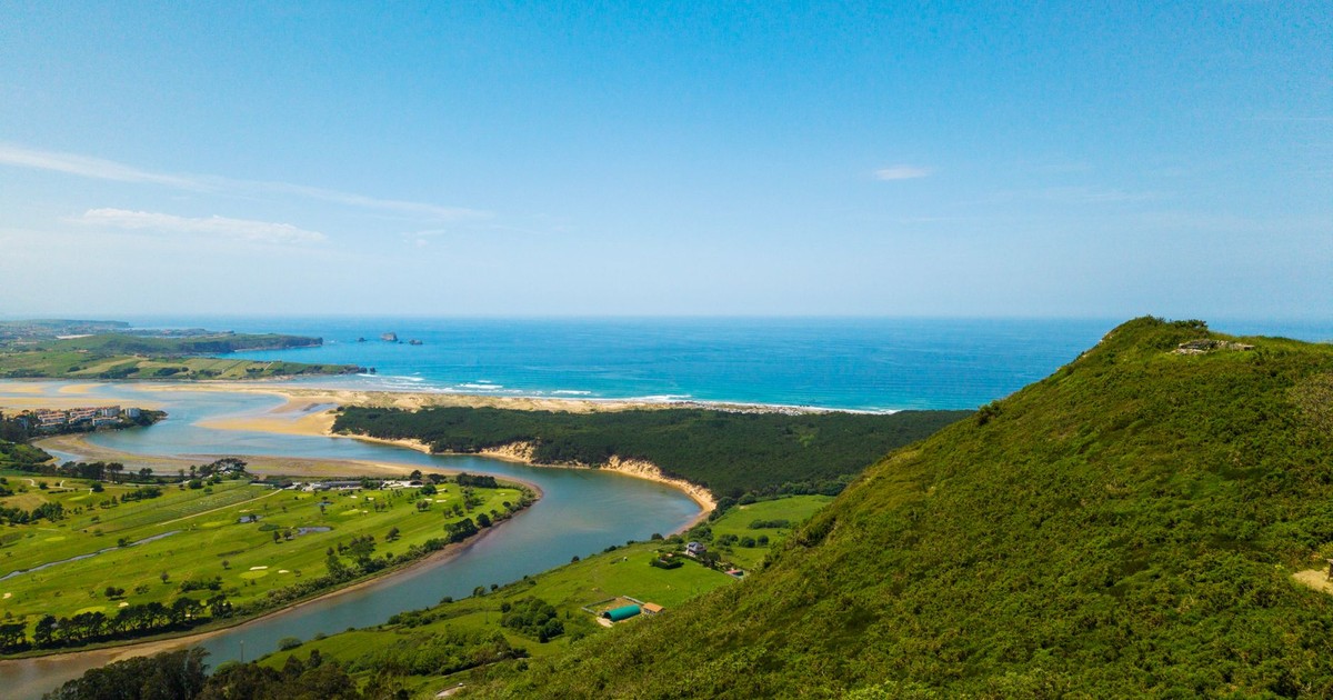 A breathtaking aerial view of the Oyambre Natural Park coastline with lush greenery and scenic ocean views.