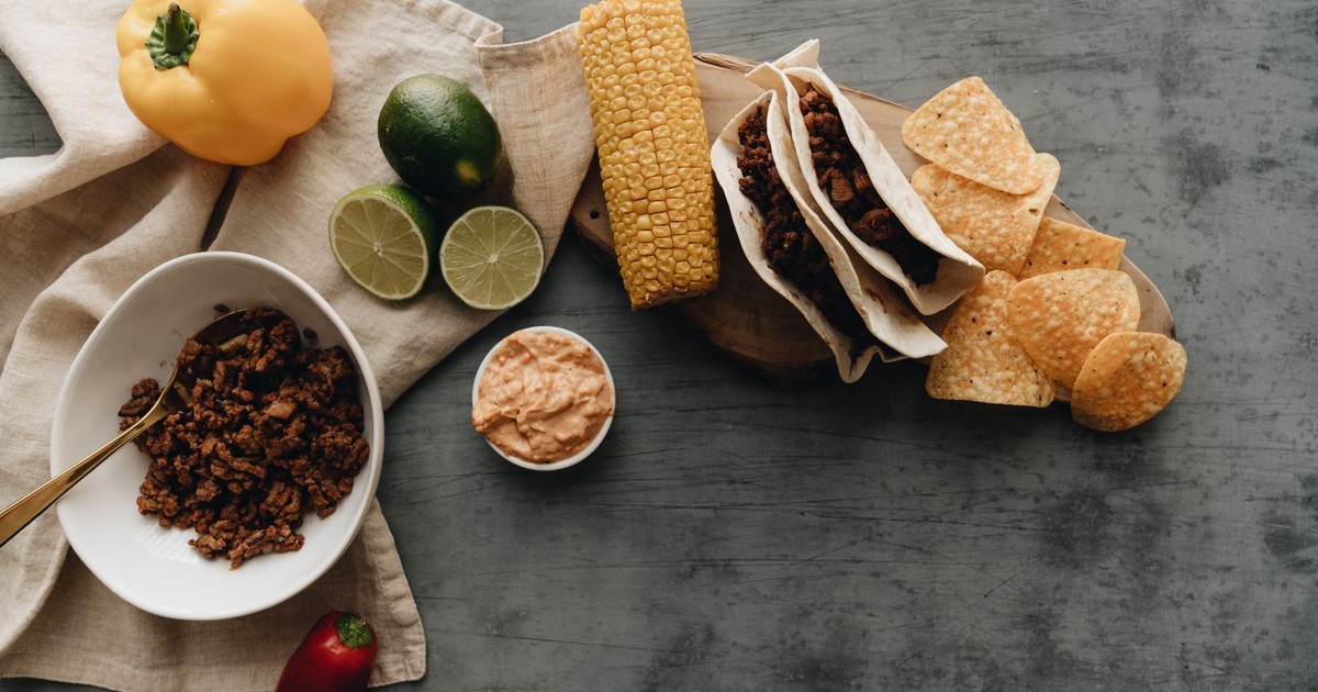 Top view of Mexican tacos with ingredients like corn and lime, perfect for a delicious meal.